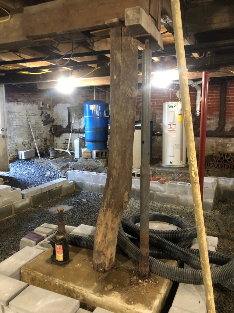 Structural Foundation Inspection of a Home in New Jersey with a log as a wood column support