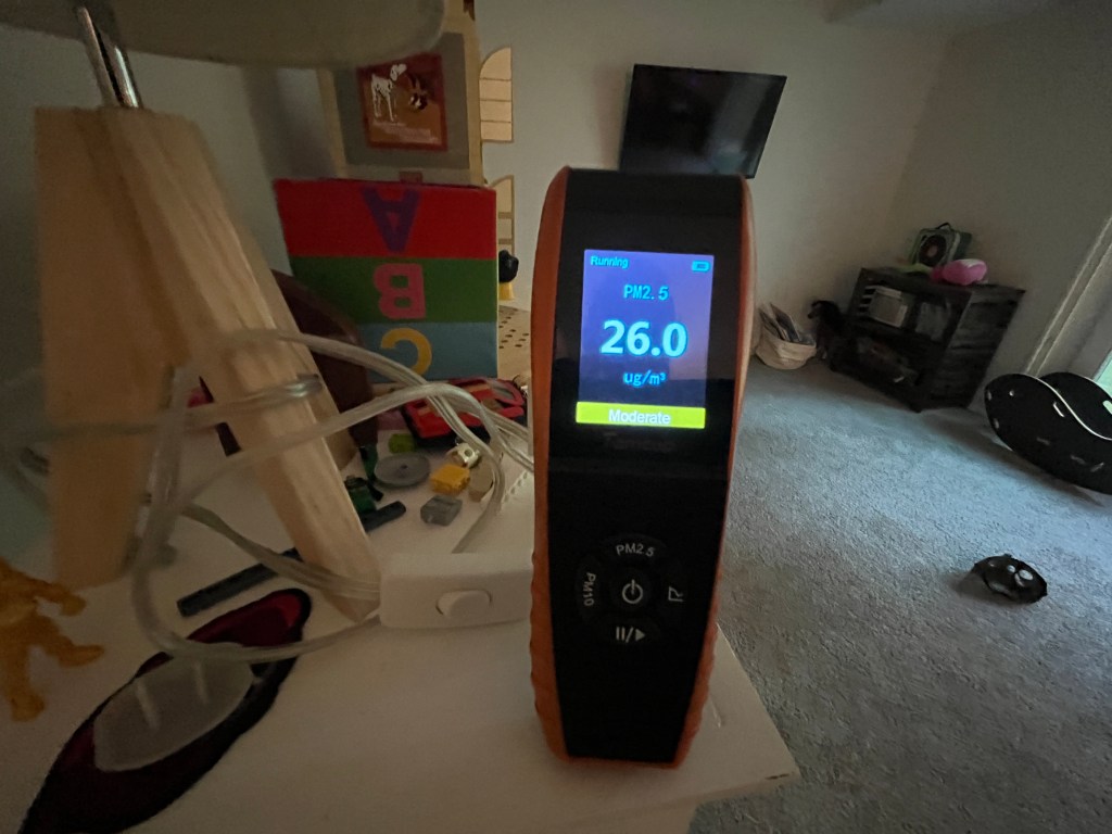 Indoor air quality testing measuring PM2.5 particulate levels inside a residential home