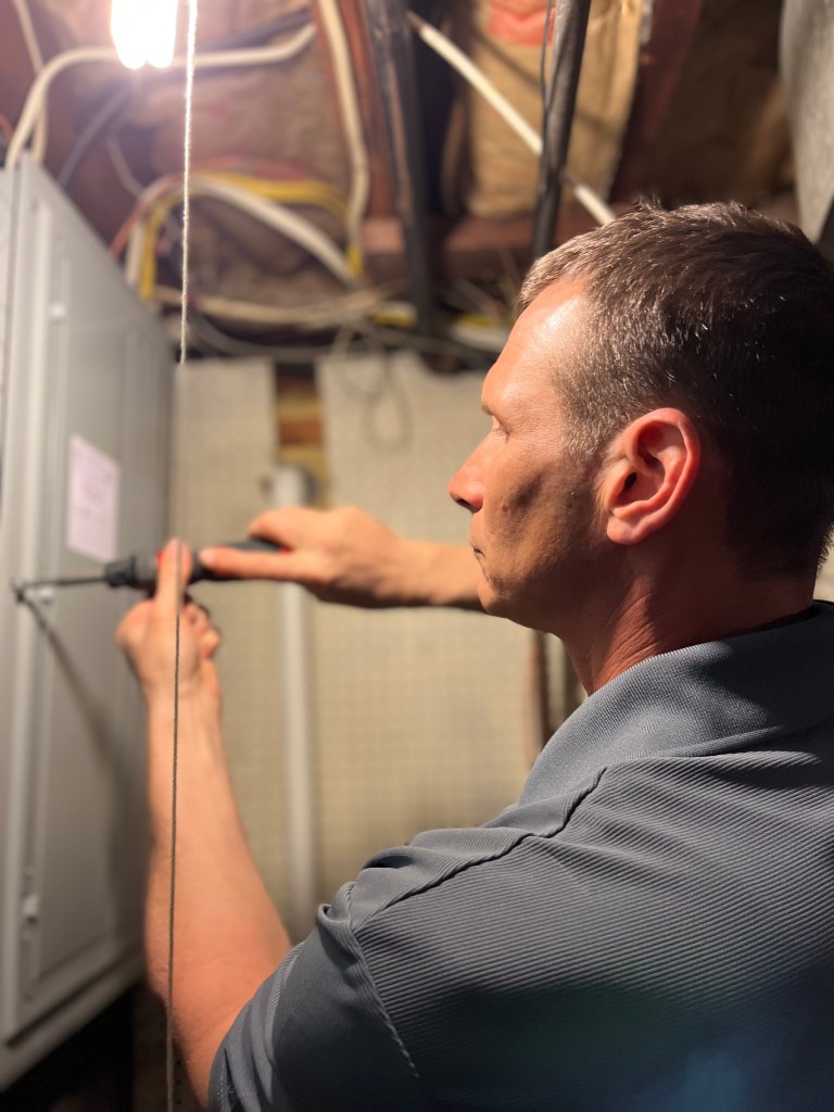 New Jersey licensed home inspector performing an electrical system inspection at a residential electrical panel