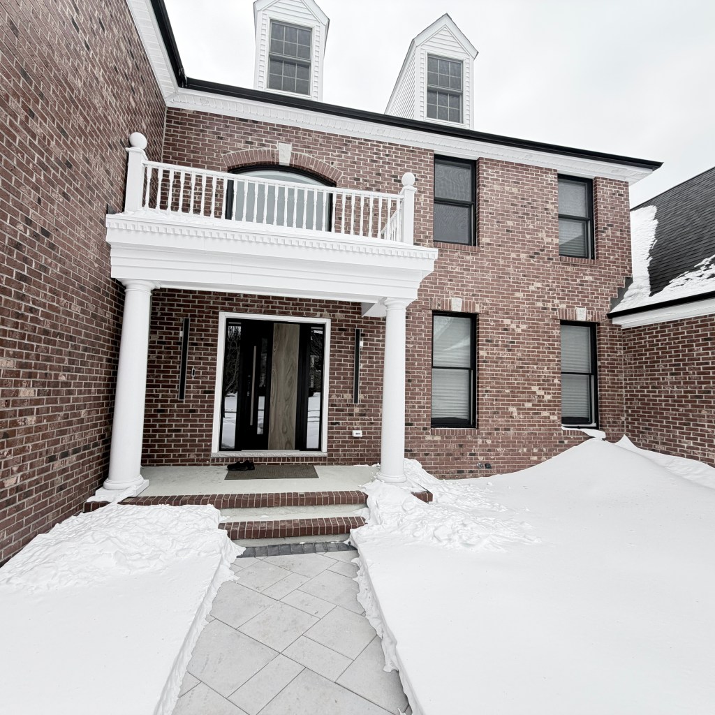 Snow surrounding a brick home in New Jersey during a winter home inspection