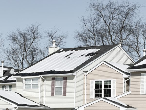 Snow-covered residential roofs in New Jersey during a winter home inspection