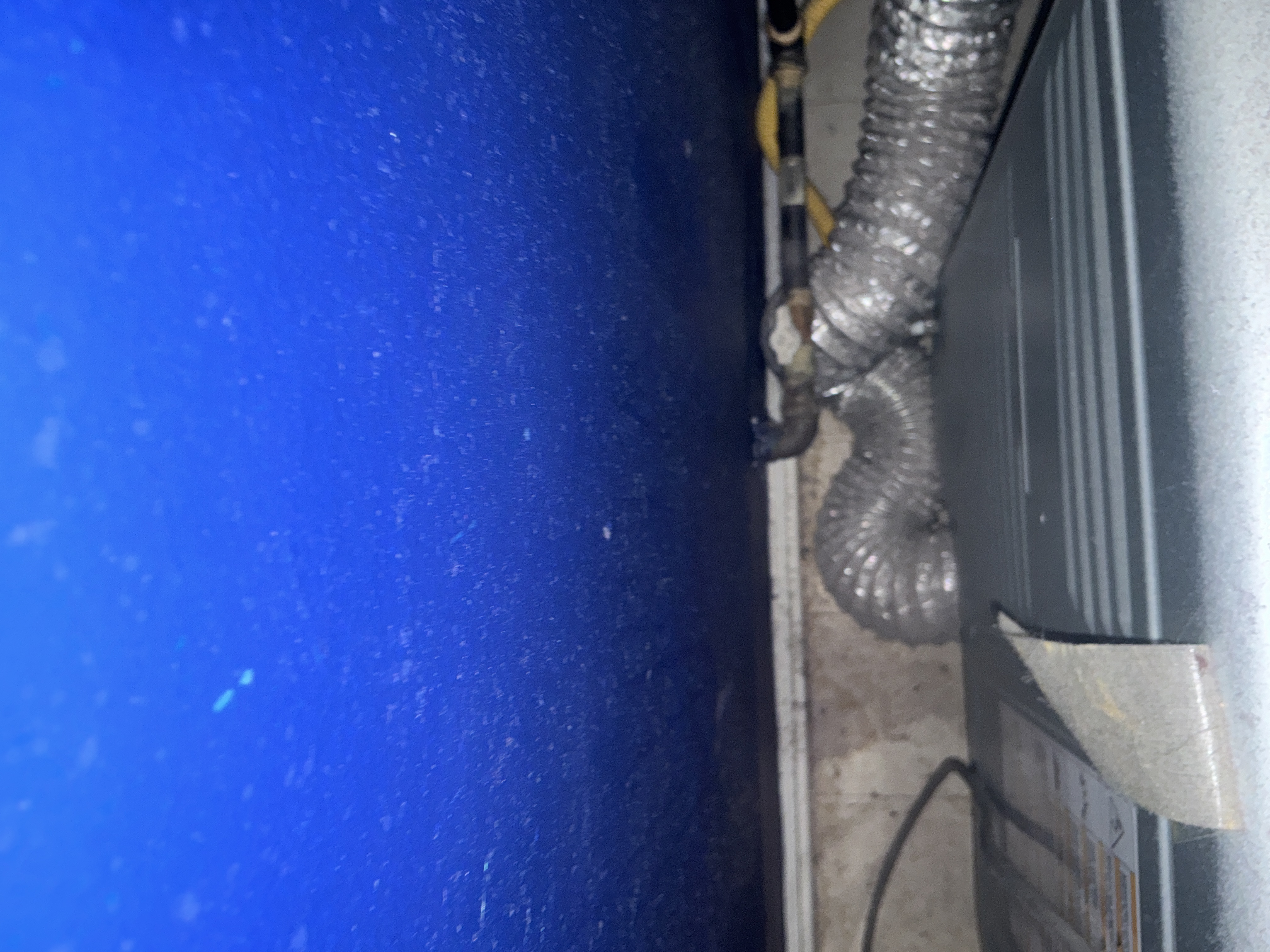 Flexible dryer exhaust connection installed behind a residential clothes dryer
